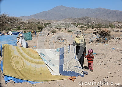 A sad Yemeni woman with her child in a camp for the displaced Editorial Stock Photo