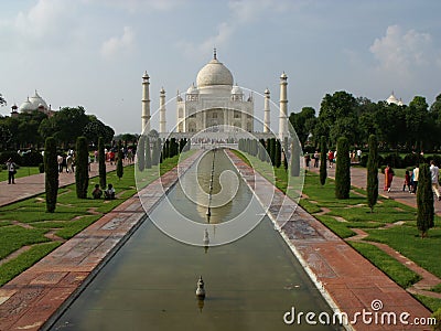White marble mausoleum surrounded by gardens, fountains and four minarets. Taj Mahal Editorial Stock Photo