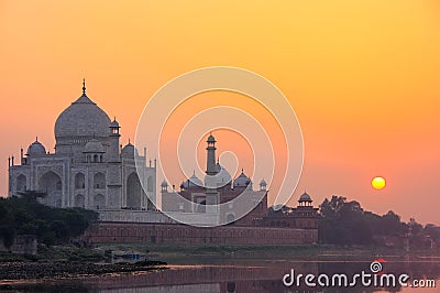 Taj Mahal reflected in Yamuna river at sunset in Agra, India Stock Photo