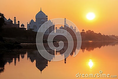 Taj Mahal reflected in Yamuna river at sunset in Agra, India Stock Photo