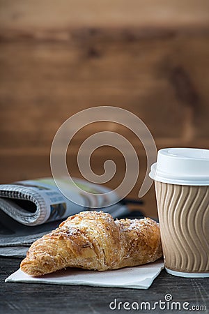 Take away coffee and fresh croissant and newspaper Stock Photo