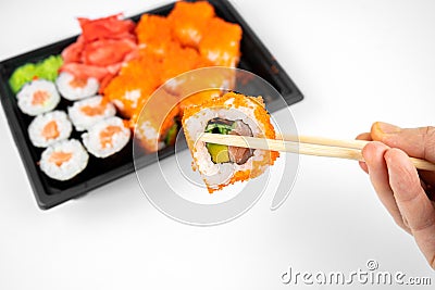 Take away sushi rolls in plastic container, california, salmon maki roll, pink ginger, wasabi. sushi delivery concept Stock Photo