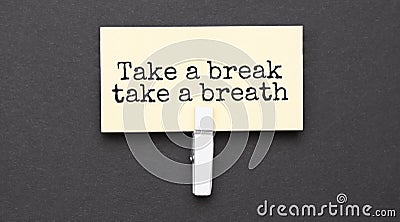 Take a break,take a breath text on paper with wihte clip. On black background Stock Photo