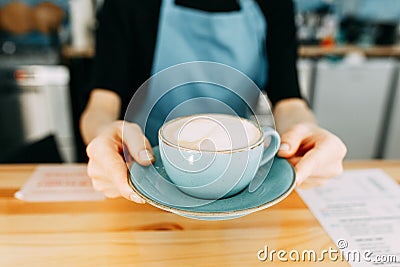 Take coffee with you at the coffee shop. Coffee mug in the hands of the Barista Stock Photo