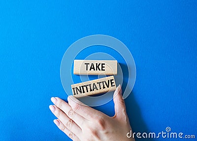 Take initiative symbol. Wooden blocks with words Take initiative. Businessman hand. Beautiful blue background. Business and Take Stock Photo