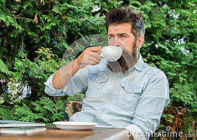 Take moment to enjoy life. Man bearded hipster make pause for drink coffee and relax while sit with laptop. Guy drinks Stock Photo