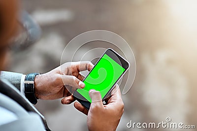 Take my digits and lets connect. Closeup shot of an unrecognizable businessman using a cellphone with a screen green in Stock Photo