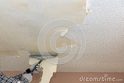 Take off in the popcorn ceiling home wall texture removal Stock Photo