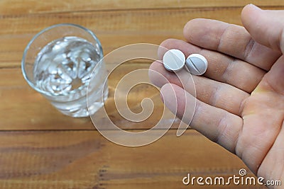 Take the pill that the doctor prescribed for the illness, and a glass of water Stock Photo