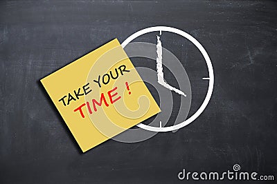 Take your time concept with alarm clock on school board Stock Photo