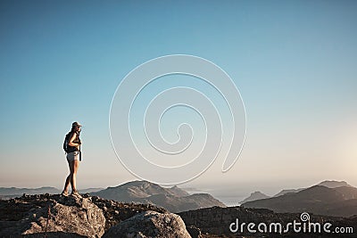 It takes courage to make it to the top. a young woman hiking up a mountain. Stock Photo