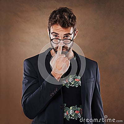 He takes looking good very seriously. Studio shot of a stylishly dressed young man. Stock Photo