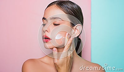 Taking good care of her skin. Beautiful woman spreading cream on her face. Skin cream concept. Facial care for female Stock Photo
