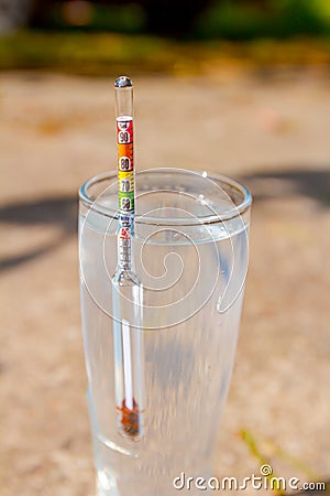 Taking liquor samples in laboratory graduated cylinder Stock Photo