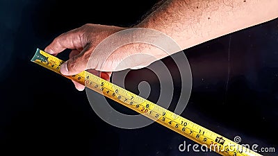 Taking measurements, conceptual photo on putting standards or limits, hands using an item of suitable suitable for multiple uses Stock Photo