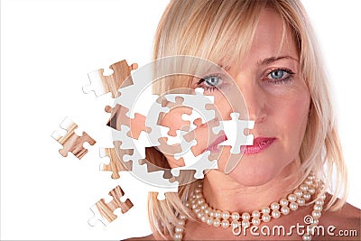 Taking off puzzle from face of middleaged woman Stock Photo