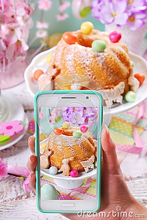 Taking photo of easter ring cake by smartphone Stock Photo
