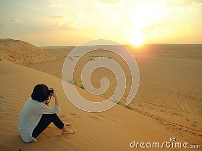 Taking photo of sunset in Wahiba desert, Oman Editorial Stock Photo