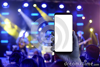 Taking photos of music concert with a mobile phone Stock Photo