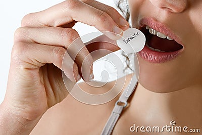 Taking pills Close-up of a white pill in woman's fingers. Stock Photo