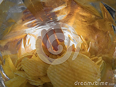 Taking salty snacks inside the bag Stock Photo