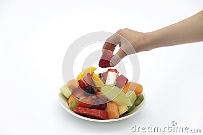 Taking a strawberry Stock Photo