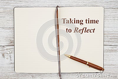 Taking time to reflect on brown journal with pen on a weathered whitewash wood Stock Photo