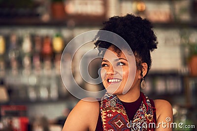 Taking a timeout at her local cafe. an attractive young woman sitting in a cafe. Stock Photo