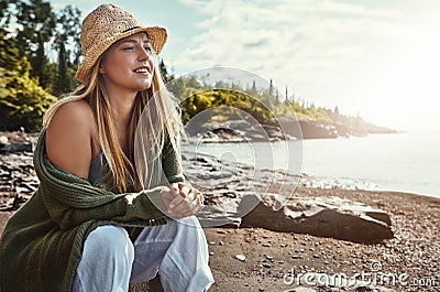 Taking a timeout at the lake. a young woman spending a day at the lake. Stock Photo