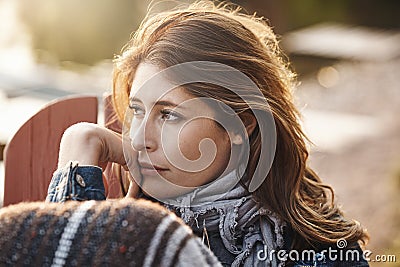 Taking a timeout for some quiet contemplation. an attractive young woman relaxing on a deck chair outdoors. Stock Photo
