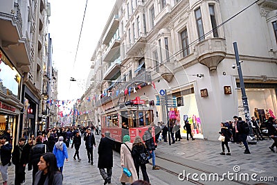 Taksim Tunel Nostalgia Tram trundles along the istiklal street and people at istiklal avenue. Istanbul, Turkey Editorial Stock Photo