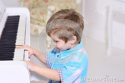 Talanted children. Music. child play piano. happy childhood. Care development. Music and art education. Little boy Stock Photo