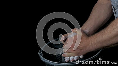 Talc sports. Closeup of a muscular man ready to workout. male powerlifter hand in talc and sports wristbands preparing Stock Photo