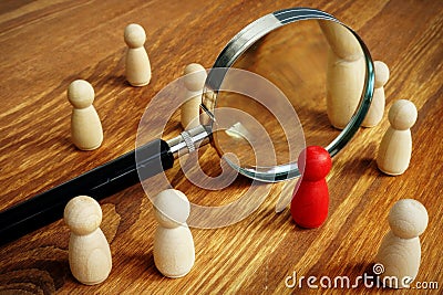 Talent acquisition and management. Magnifying glass and figurines Stock Photo