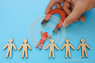 Talent employee attracting and recruitment. Red figure and magnet. Stock Photo