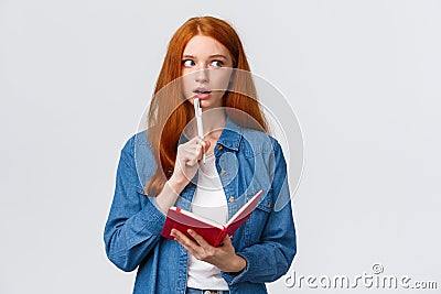 Talented, creative good-looking redhead woman writing poem, story, taking notes, prepare grocery list, gasping recall Stock Photo