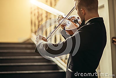 Talented gorgeous man play violin Stock Photo