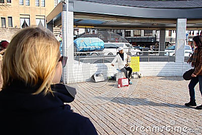 Talented Japanese street performer busking at the traffic lights Editorial Stock Photo