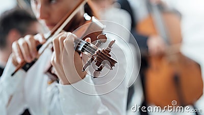 Talented violinist playing with orchestra Stock Photo