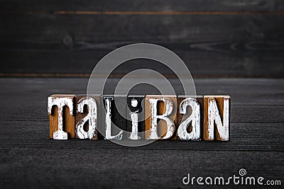 Taliban. Afghanistan's political and culture. White wooden letters on a dark wooden background Stock Photo