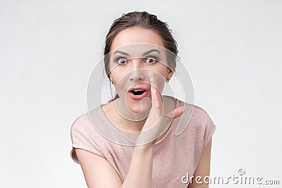 Talkative woman is saying secret hot braking news and looking to her friend Stock Photo