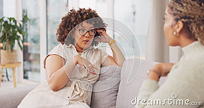 Talking, bonding and friends sharing a story, secret or gossip on the sofa together. Happy, relax and women on the Stock Photo