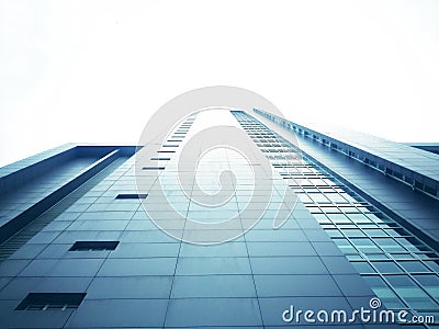 The tall building from the bottom view has a white sky background Stock Photo
