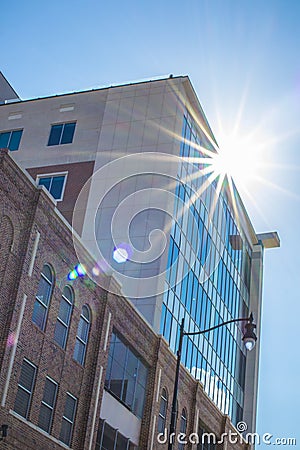 Tall building downtown with sun beam off the edge Editorial Stock Photo