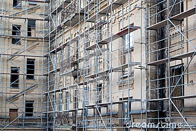 Tall building under construction with scaffolds. Scaffold. Construction Scaffoldings. Stock Photo