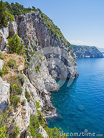 Tall cliffs and clear blue water Stock Photo