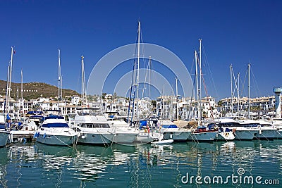 Tall luxury boats and yachts moored in Duquesa port in Spain on Stock Photo