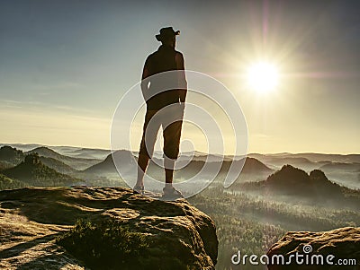 Tall man feel free above large Valley wearing cowboy hat Stock Photo