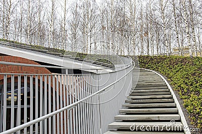 Tall modern winding staircase with railings Stock Photo