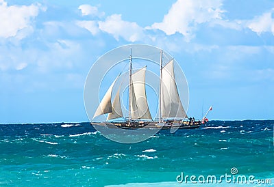 Tall sailing ship with sails on choppy ocean. Stock Photo